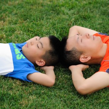 dad-and-son-lying-on-grass-1628