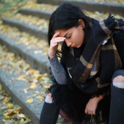 Depressed young woman outdoors