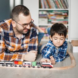 preschool-boy-and-dad-playing-with-wooden-train-501