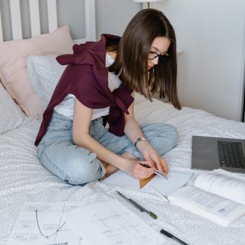 teen-girl-studying-on-bed-EF-1307