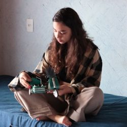 teen sitting legs crossed on bed chronic illness 1012