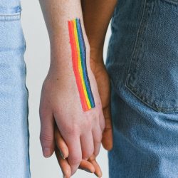 teens rainbow flag holding hands 1114