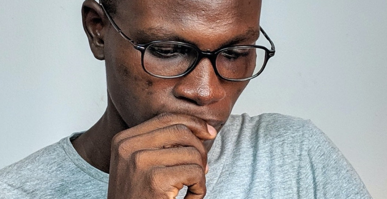 Photo of man looking down pensively