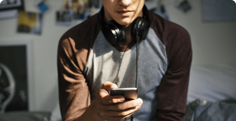 card-photo-Social Media Can Boost Teens Self-Esteem or Foster Depression@2x Photo of teen boy viewing phone