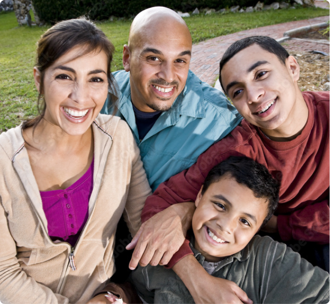 Photo of a smiling family consisting of mother, father and two boys